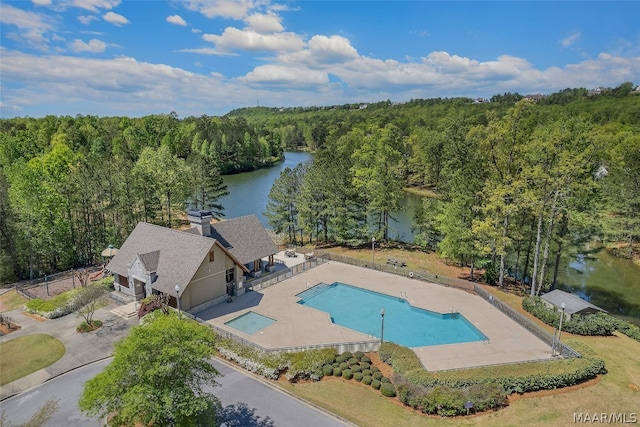 view of pool featuring a patio and a water view