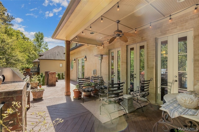 view of patio featuring ceiling fan, a deck, and french doors