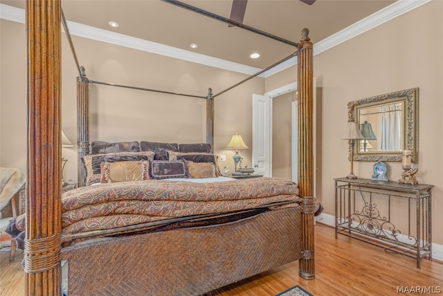 bedroom with hardwood / wood-style flooring and crown molding