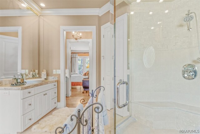 bathroom with large vanity, a notable chandelier, tile floors, a shower with shower door, and ornamental molding