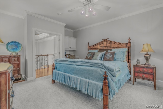 carpeted bedroom featuring ornamental molding and ceiling fan