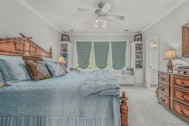 carpeted bedroom featuring ceiling fan, crown molding, and ensuite bathroom