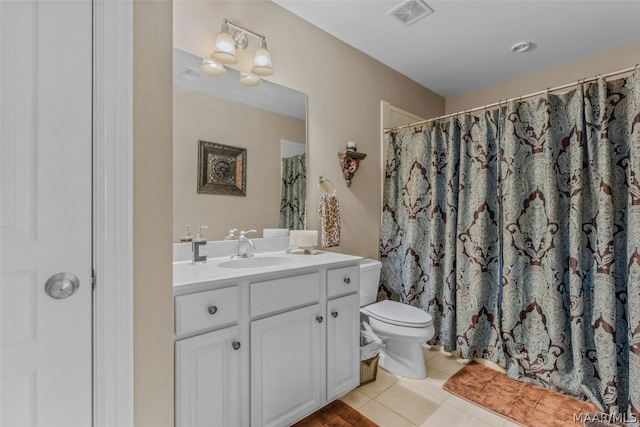 bathroom with vanity, toilet, and tile floors