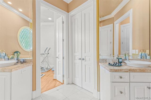 bathroom with wood-type flooring, vanity, and crown molding