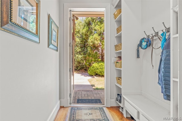 mudroom featuring built in features and light wood-type flooring