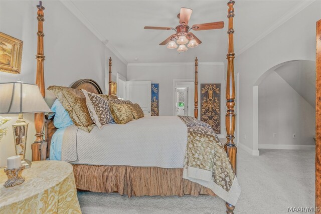 carpeted bedroom with ornamental molding and ceiling fan