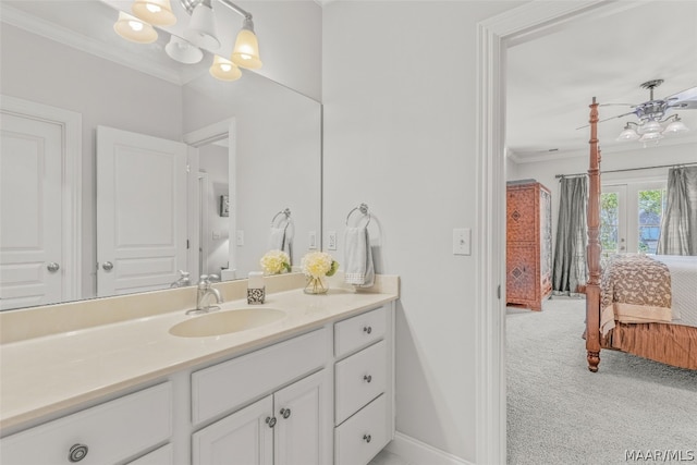 bathroom with ornamental molding and vanity with extensive cabinet space