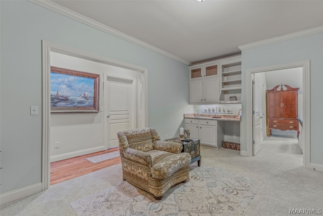 sitting room featuring light colored carpet and crown molding