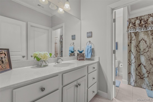 bathroom featuring ornamental molding, toilet, tile floors, and vanity