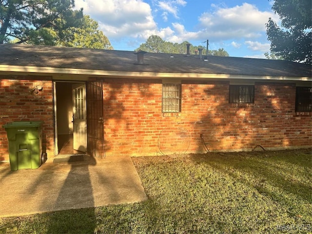 back of house with a lawn