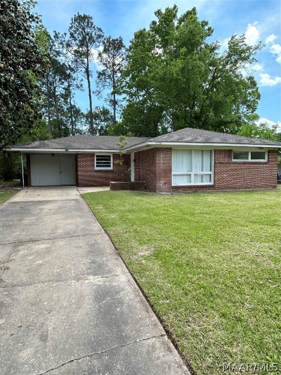 ranch-style home featuring a front yard and a carport