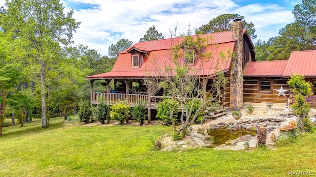 rear view of house with a yard