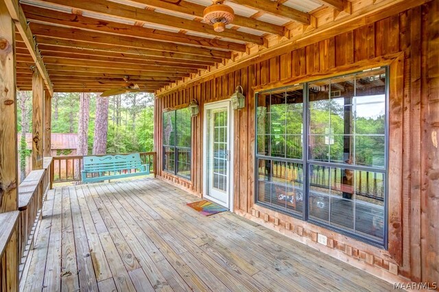 wooden deck with covered porch and ceiling fan