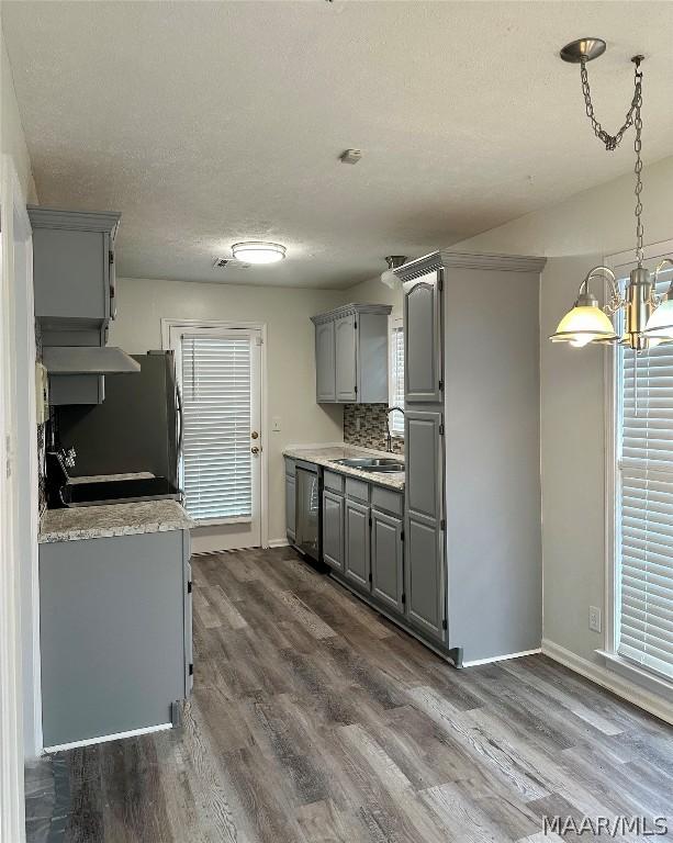 kitchen with gray cabinets, a wealth of natural light, dark hardwood / wood-style flooring, and sink