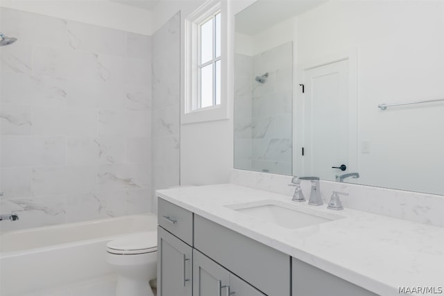 full bathroom with toilet, oversized vanity, and tiled shower / bath combo