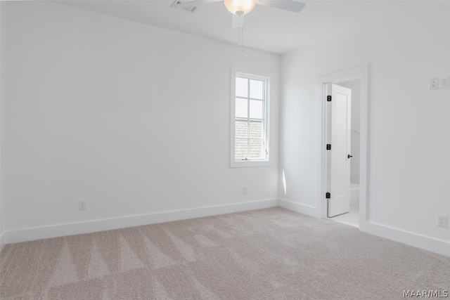 unfurnished room featuring light carpet and ceiling fan