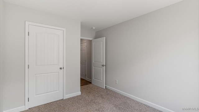 unfurnished bedroom with carpet flooring and a closet