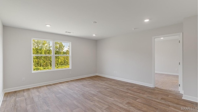 spare room with light hardwood / wood-style flooring