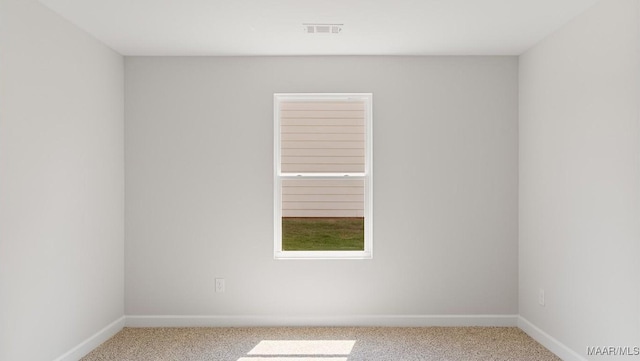 unfurnished room with light colored carpet