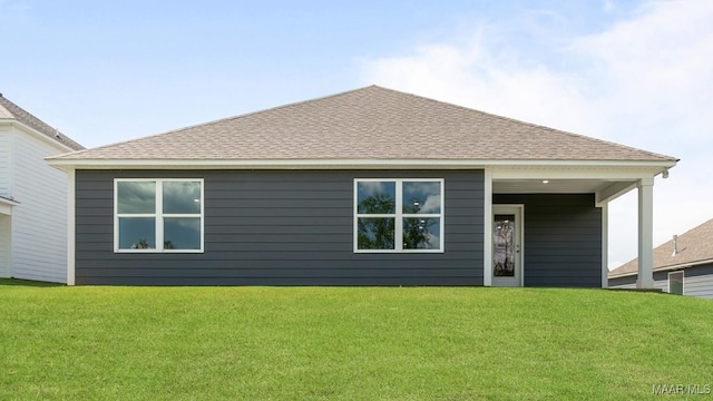 rear view of property with a yard