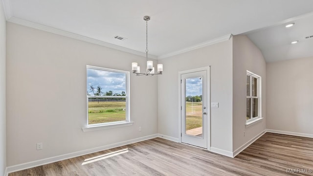 6601 Firefly Ln, Montgomery, AL 36116 - unfurnished dining area featuring a chandelier, wood finished floors, crown molding, and baseboards