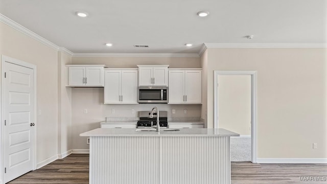 6601 Firefly Ln, Montgomery, AL 36116 - kitchen featuring stainless steel appliances, a sink, light countertops, dark wood-style flooring, and ornamental molding