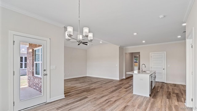 6601 Firefly Ln, Montgomery, AL 36116 - kitchen with a sink, ornamental molding, a chandelier, wood finished floors, and an island with sink