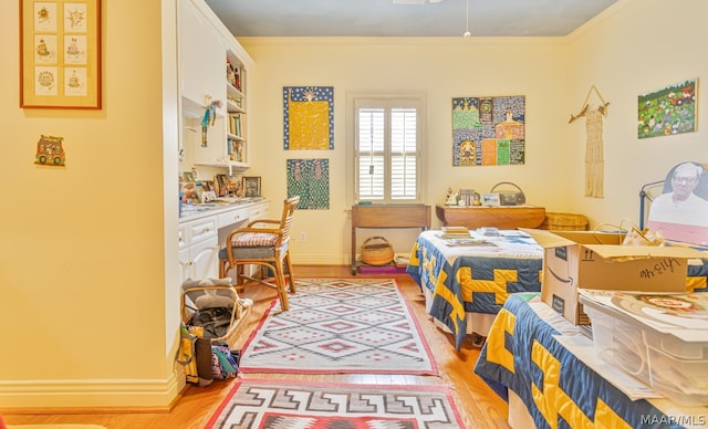 bedroom featuring crown molding and light wood-type flooring