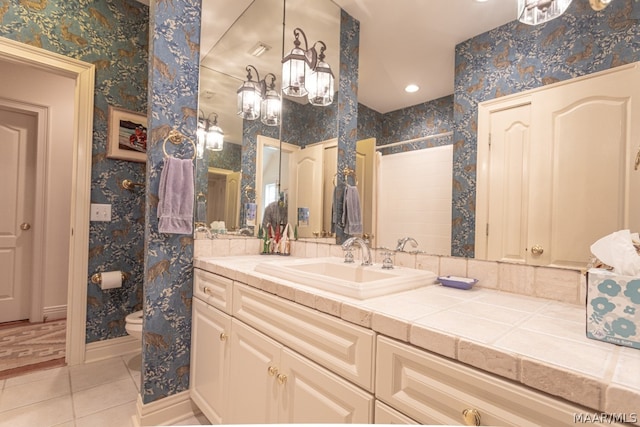 bathroom featuring large vanity, an inviting chandelier, tile floors, and toilet