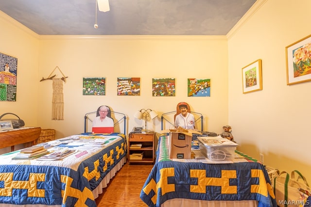 bedroom featuring hardwood / wood-style floors, ceiling fan, and ornamental molding