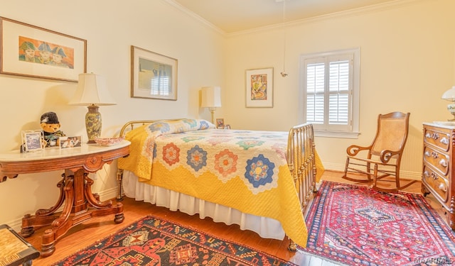 bedroom with crown molding and wood-type flooring