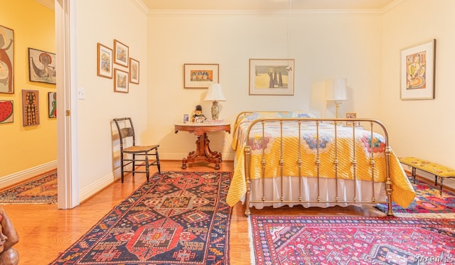 bedroom with ornamental molding and wood-type flooring