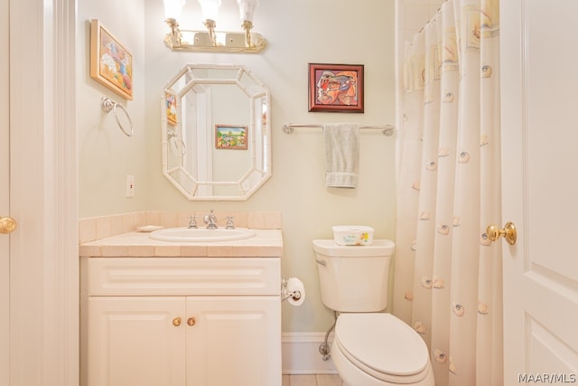 bathroom with toilet, tile flooring, and vanity