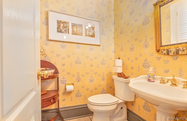 bathroom featuring tile flooring and toilet