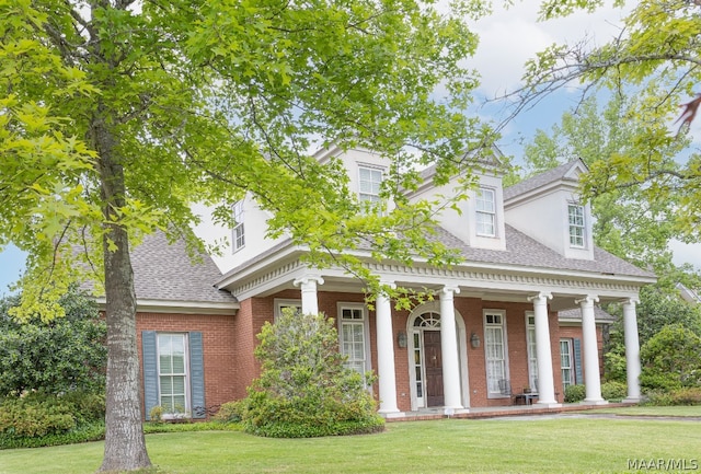 view of front of property with a porch and a front yard