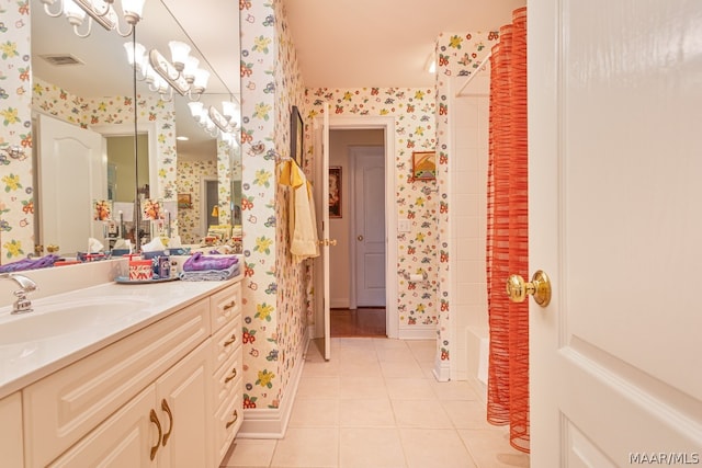 bathroom with a chandelier, tile floors, and vanity