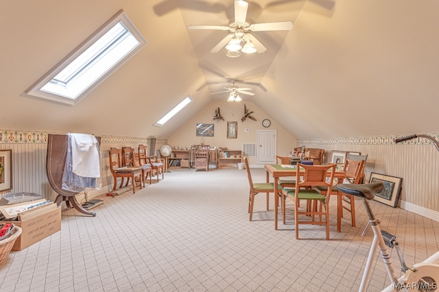 interior space with light carpet, lofted ceiling with skylight, and ceiling fan