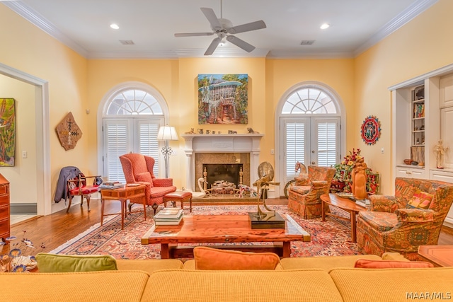 living room featuring french doors, ceiling fan, crown molding, and hardwood / wood-style flooring