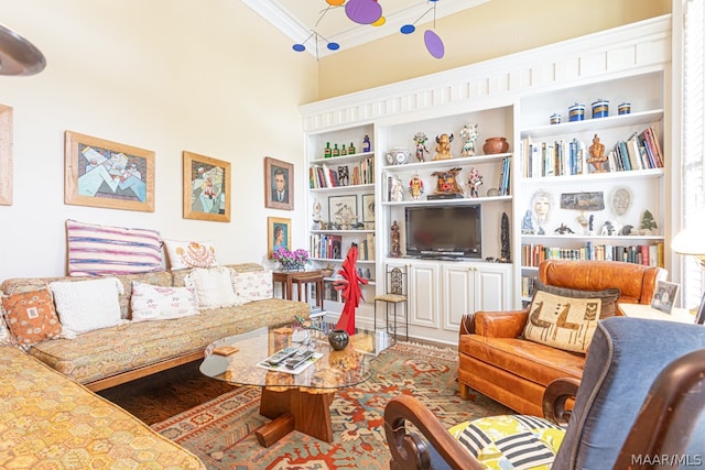 living room featuring built in features, crown molding, and wood-type flooring