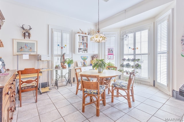 dining area featuring a chandelier, crown molding, and light tile floors