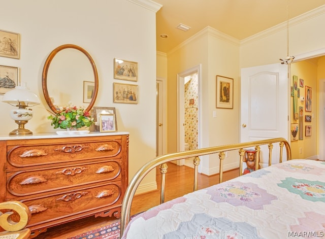 bedroom with hardwood / wood-style flooring and ornamental molding