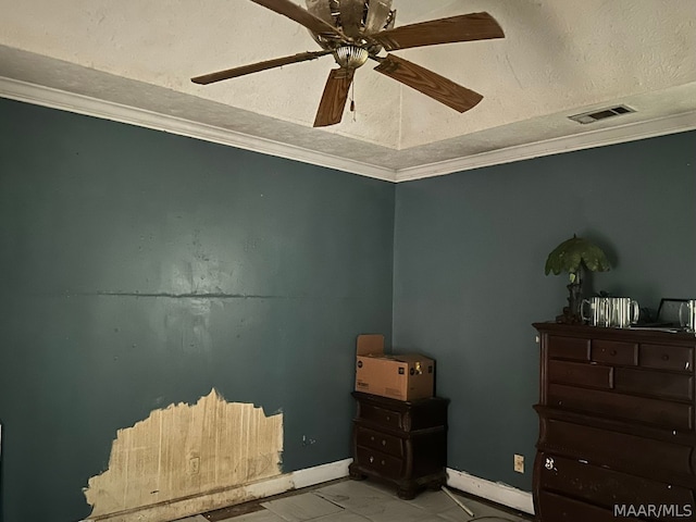 interior space with ornamental molding, ceiling fan, and a textured ceiling