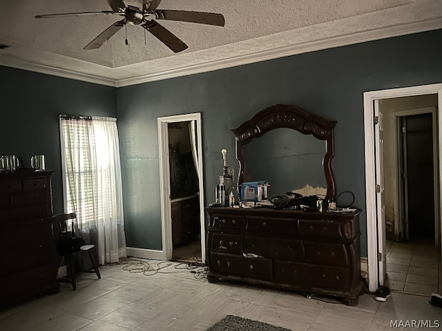 tiled bedroom featuring ornamental molding, connected bathroom, ceiling fan, and a textured ceiling