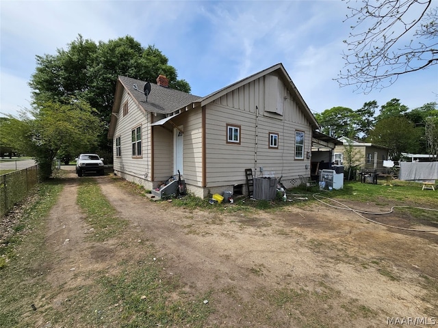 view of side of home with central air condition unit