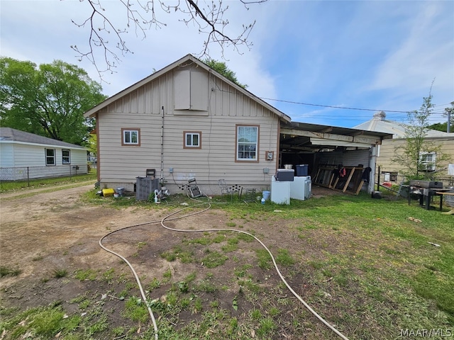 back of house featuring central AC unit