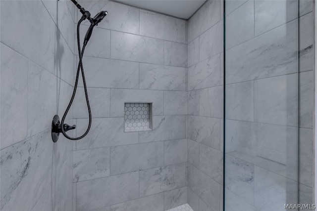 bathroom with tiled shower