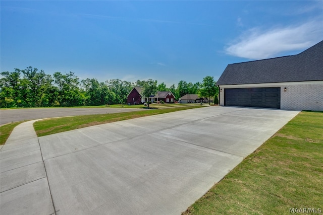 view of property exterior with a lawn and a garage