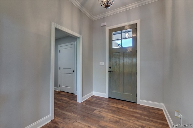 foyer featuring ornamental molding, dark wood-type flooring, and a chandelier