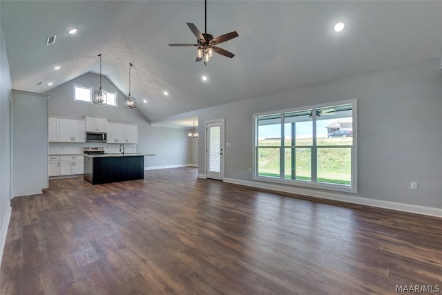 unfurnished living room with high vaulted ceiling, dark hardwood / wood-style flooring, and ceiling fan