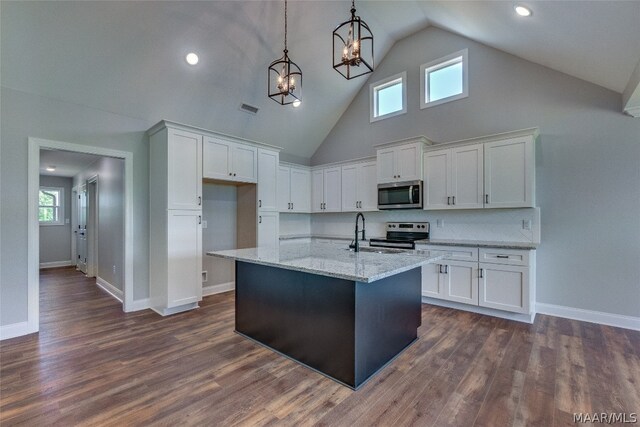 kitchen featuring stainless steel appliances, white cabinetry, high vaulted ceiling, and pendant lighting